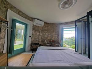 a bedroom with a large bed and a window at Torre del Principe suite in Salerno