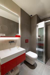 a bathroom with a toilet, sink, and shower at Hotel Favori Nisantasi in Istanbul