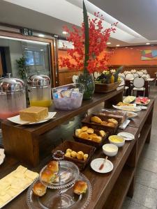 a buffet line with pastries and other food items at Hotel Oscar Gold Savassi in Belo Horizonte +16 photos