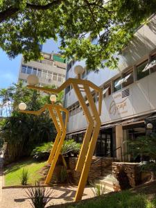 a yellow statue in front of a building at Hotel Oscar Gold Savassi in Belo Horizonte