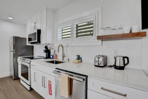 a white kitchen with a sink and a counter top at Palmetto Paradise - B in St. Augustine