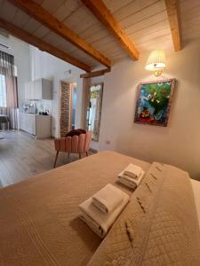 1 dormitorio con 1 cama con 2 toallas en Affittacamere Louis, en Cagliari