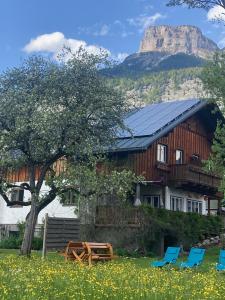 a house with chairs and a mountain in the background at Heli's Holiday Suites, 8992 Altaussee, Suites "Dachstein", "Sarstein", "Trisselwand" in Altaussee