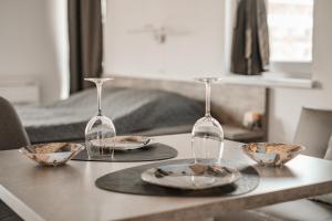 a table with two wine glasses and bowls on it at July's Guest House in Primorsko