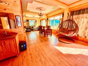a large living room with a table and chairs at Woods Villa Cottage, Manali in Manāli