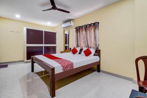 a bedroom with a bed and a window at OYO AR Guest House in Visakhapatnam