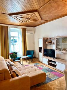 a living room with a couch and a flat screen tv at Apartment Riva in Makarska