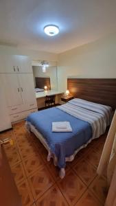a bedroom with a large bed with a tray on it at Hotel NIKYASAN in Antofagasta