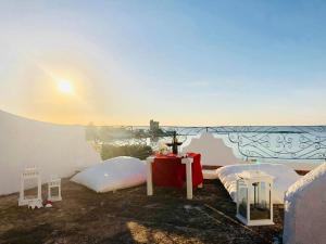 a room with two beds and a table and a wall at Villa GAUDÌ in Sant'Isidoro