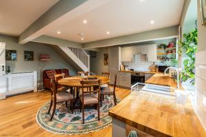 a kitchen and dining room with a table and chairs at Stable Cottage in Teffont Magna
