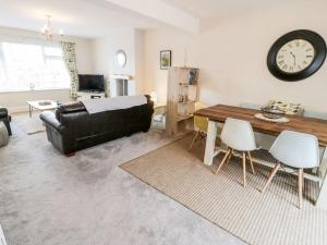 a living room with a couch and a table at Ty Ni in Dyffryn