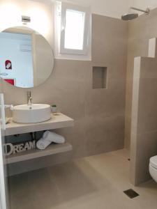 a bathroom with a sink and a mirror at Eleni Dream Village in Parikia