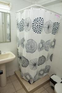 a shower curtain in a bathroom with a sink at Hotel NIKYASAN in Antofagasta