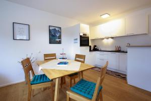 a kitchen and dining room with a table and chairs at Wohlfühlapartment 47 in Götzis