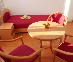 a room with a table and chairs and a couch at BALATON ART Guesthouse in Balatonszemes