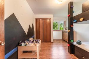 a living room with a table and a kitchen at Mountain Escape: with Sauna near Yellowstone in Bozeman