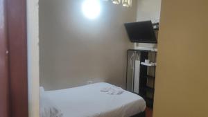 a small room with a bed and a flat screen tv at Nuevo hospedaje benny in Melgar