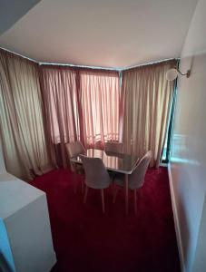 um quarto com uma mesa e cadeiras e uma janela em Crystal boulevard hôtel em Tânger