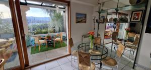 a dining room with a glass table and a balcony at 2 chambres et canapé lit bureau - Marina Plage - Agréable in Hendaye