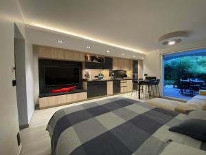 a living room with a bed and a kitchen with at LE KALI in Cavalaire-sur-Mer