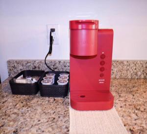 a red blender on a counter with a box of cupcakes at NEW Charming Escape 3 BD King Suite East of Birmingham 
