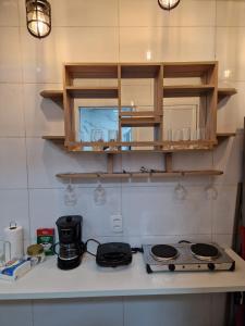 a kitchen counter top with a stove and cabinets at Beira Mar Copa in Rio de Janeiro