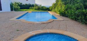 a swimming pool in the middle of a patio at Villa MORELL in Cala Morell