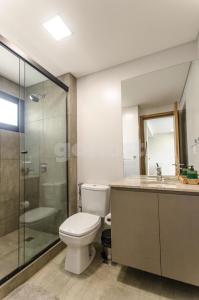 a bathroom with a toilet and a glass shower at Delightful Apt Two Minutes Away From La Galeria in Asuncion