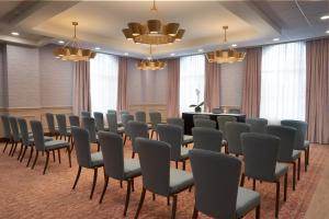 a conference room with chairs and a podium at Hotel Vesper, Houston, a Tribute Portfolio Hotel in Houston