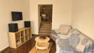 a living room with a couch and a table at WavePortugal Surf & Stay in Raposeira