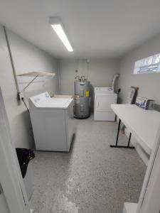 a laundry room with a washer and dryer at Riverside Retreat: Deck Bar, FirePit, Boat Parking in Fort Myers +24 photos