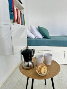 a coffee table with two cups and bread on it at La dolce vita in Mala