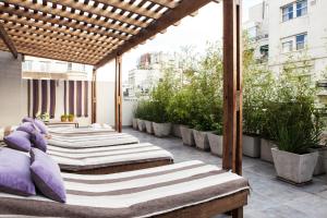 a row of beds on a balcony with plants at Casa Bevant in Buenos Aires