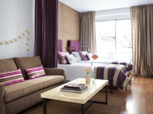 a living room with a couch and a bed at Casa Bevant Hotel Boutique in Buenos Aires