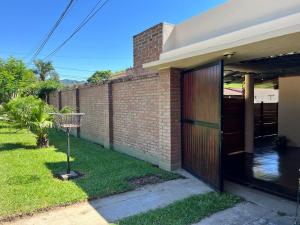 a brick house with a door and a yard at PATASTAY in San Salvador de Jujuy