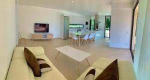 a living room with a couch and a table at Villa SONIA in Cala en Blanes
