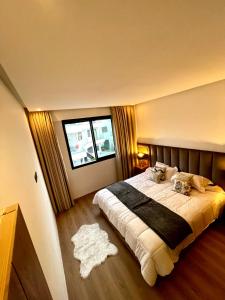 a bedroom with a large bed and a window at 2BR Agadir Apartment with Pool and Netflix in Agadir