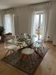 a dining room with a glass table and chairs at Interno 12 Sweet Home in Verona
