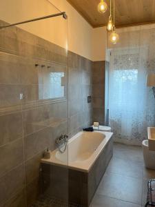 a large bathroom with a tub and a sink at Interno 12 Sweet Home in Verona