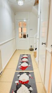 a hallway with a kitchen with red dishes on a rug at Double room in Greater London (Hackney) in London