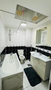 a bathroom with a tub and a sink and a toilet at Double room in Greater London (Hackney) in London