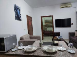 a living room with a table with dishes on it at Cozy Home 3 in Amman +58 photos