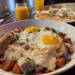 a plate of breakfast food with eggs and potatoes at Hotel Alex Johnson Rapid City, Curio Collection by Hilton in Rapid City