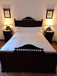 a bedroom with a large bed with two night stands at Casa rural Villa Manuela in Cazalla de la Sierra