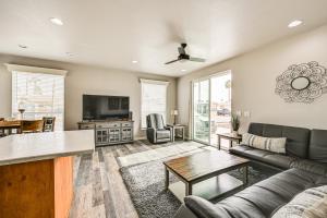 a living room with a couch and a table at Yuma Home with Fire Pit and Outdoor Community Pool! in Yuma