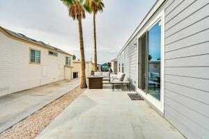 a patio with chairs and a table next to a building at Yuma Home with Fire Pit and Outdoor Community Pool! in Yuma