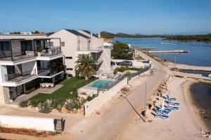 an aerial view of a house next to the water at Bonaventura Residence in Murter