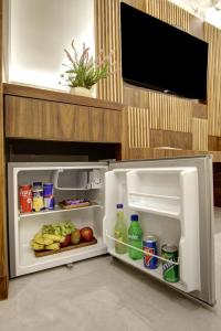 an open refrigerator filled with food and drinks at BLESS INN - Near Connaugt Place in New Delhi