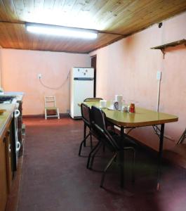a kitchen with a table and chairs and a refrigerator at Casa 3 ambientes hasta para 5 personas in Gualeguaychú