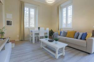 a living room with a couch and a table at [*ViLLA GiUSTi LiBERTY HOME*] SPA BBQ Wifi Parking in Lucca